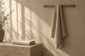 Loam Waffle Towel in soft daylight against warm plaster